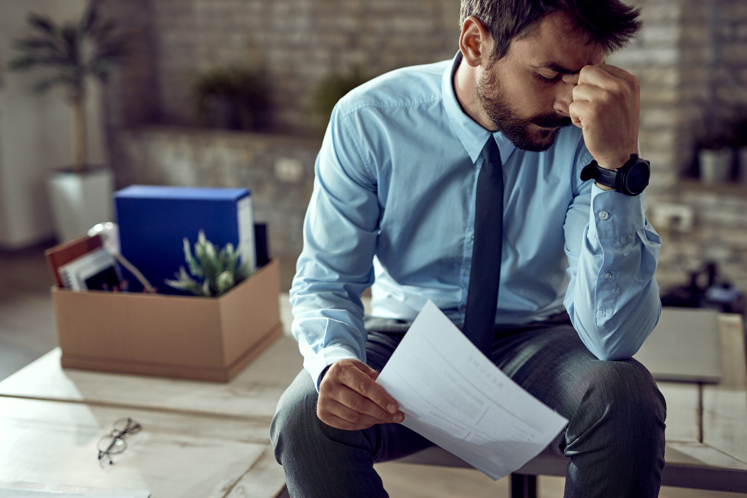 Young frustrated businessman holding a CV